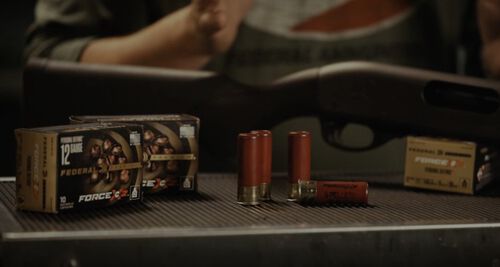 Jim Gilliland looking down a shotgun at an indoor range