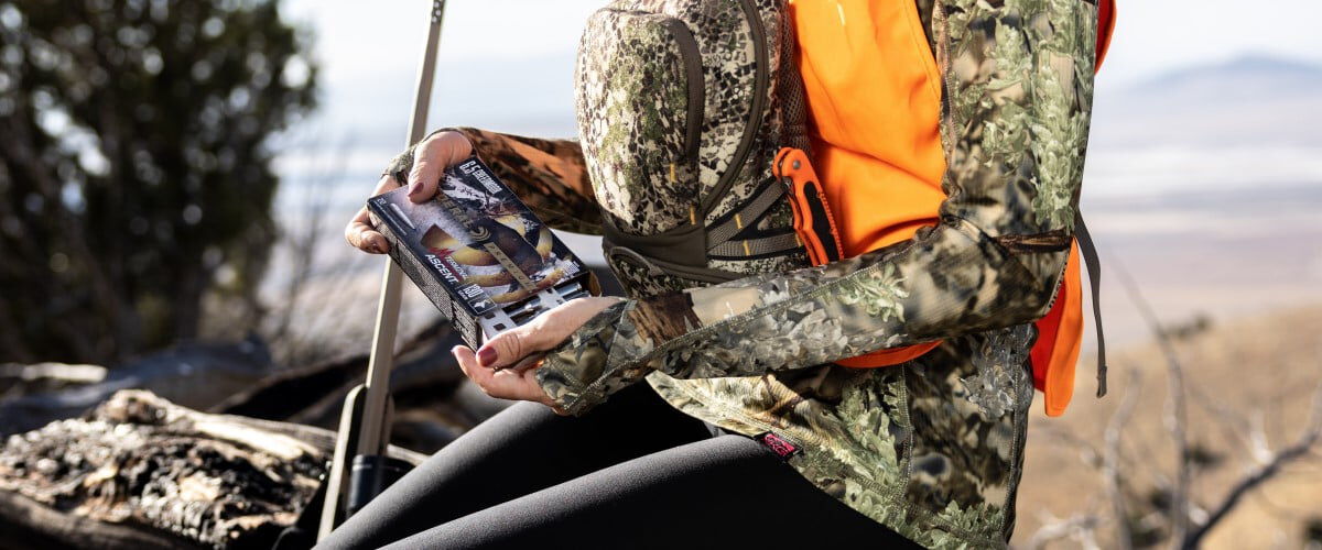 female hunter taking Terminal Ascent cartridges out of its packaging