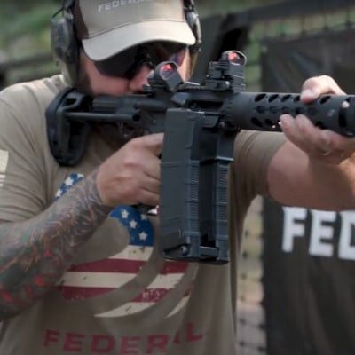 Josh holding a rifle with a coupled magazine