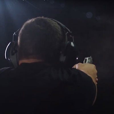 shooter at an indoor range shooting at a target
