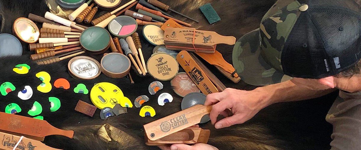 Different turkey calls spread out on a table