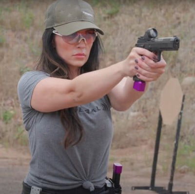 Krystal Dunn aiming a pistol
