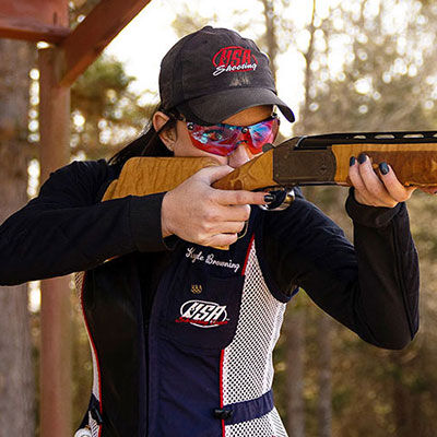 Kayle Browning shooting a shotgun