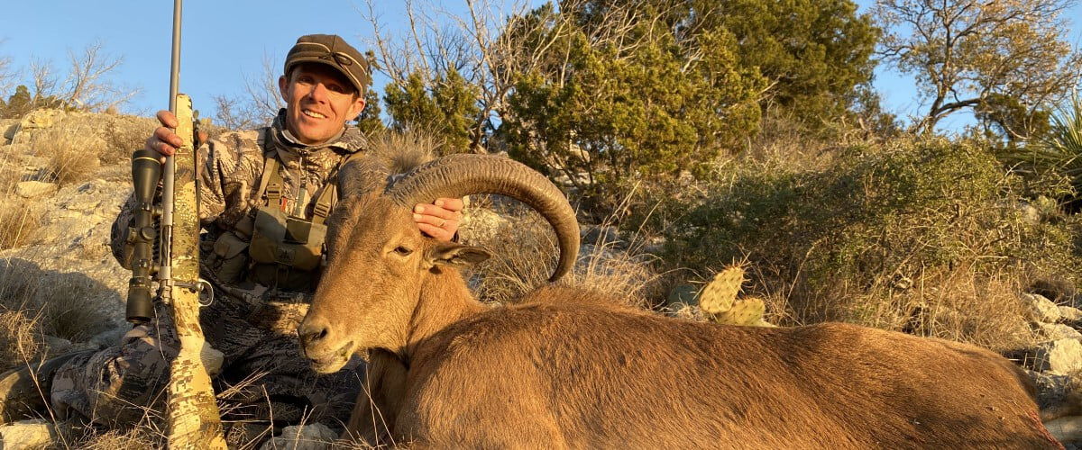 hunter beside a shot mountain goat