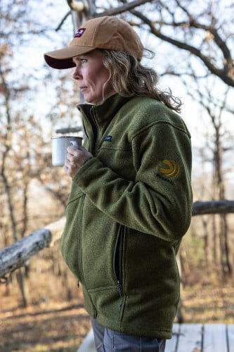 female wearing Zenith Jacket while holding a mug outside