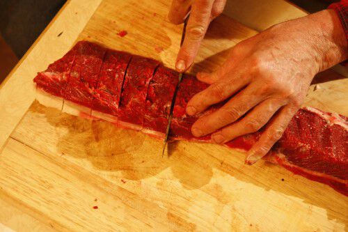 cutting deer tenderloin into sections