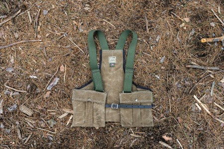 Upland Game Vest laying on the ground with sticks and pine needles