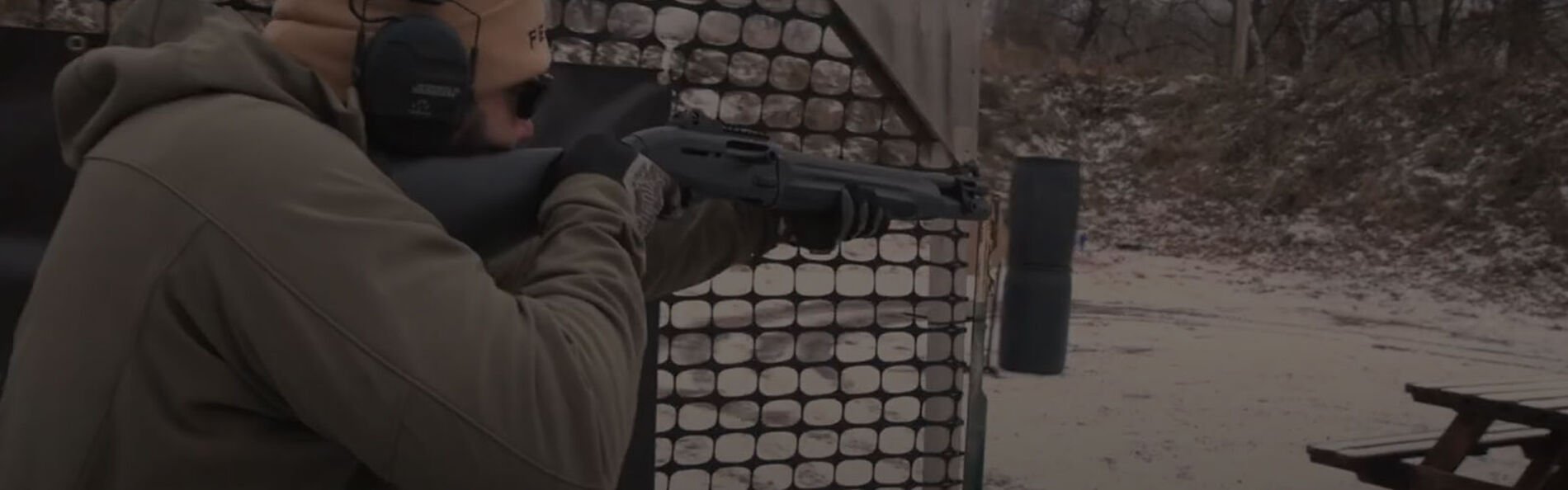 Josh Froelich aiming shotgun at an outdoor range