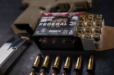 Punch Hellcat packaging and cartridges in front of a Springfield Armory Hellcat