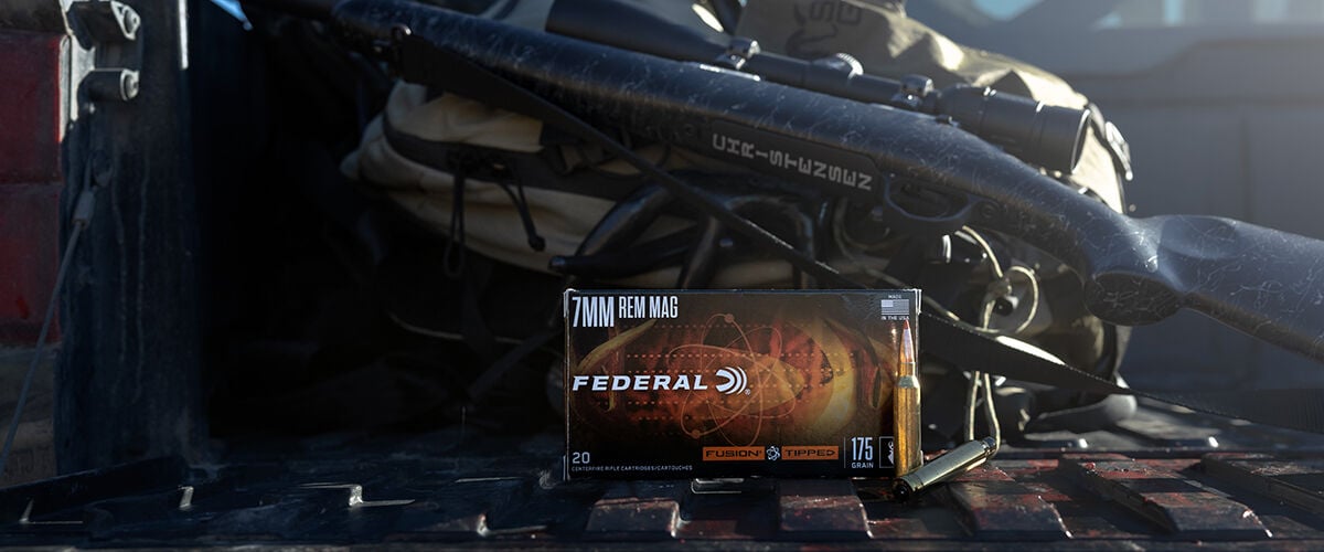 box of Fusion Tipped next to a rifle and backpack on a truck tailgate