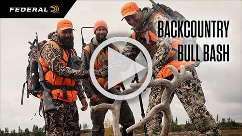 The Perfect Caribou Cartridge; Josh Froelich aiming rifle and hunters walking up on a dead caribou
