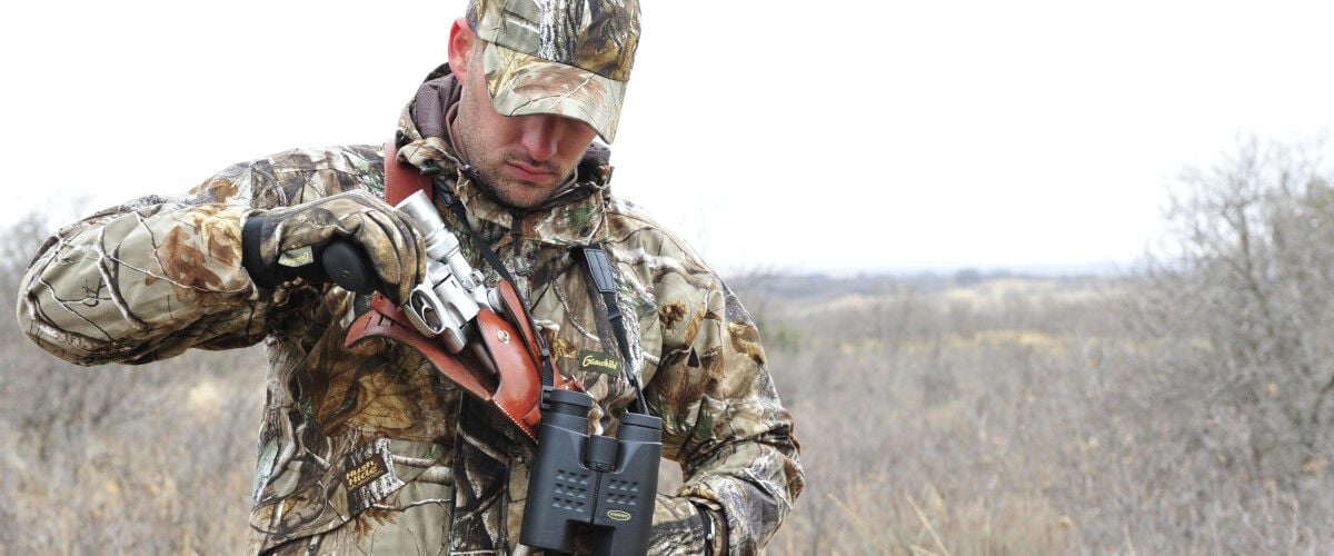 hunter loading handgun in the field