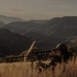 hunter looking down the scope of a rifle