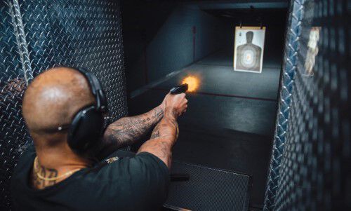 man shooting at a target at in indoor range