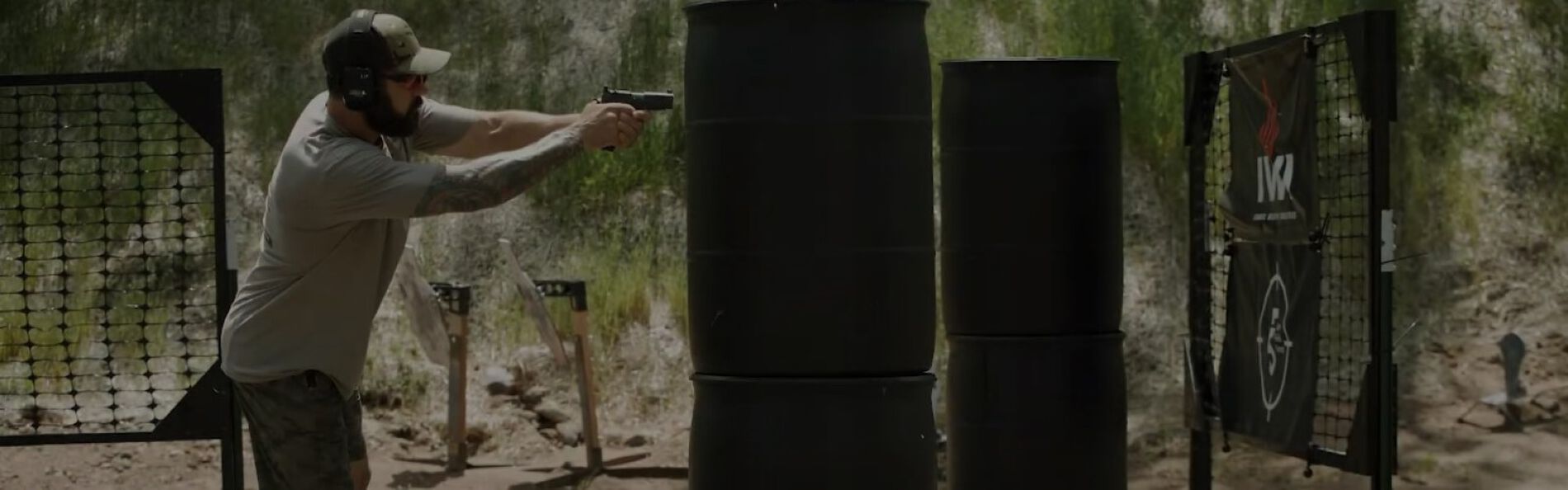 Josh Froelich shooting a pistal at an outdoor range