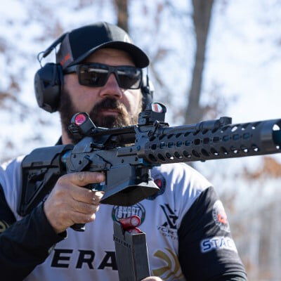 Josh Froleich loading a magazine into a shotgun