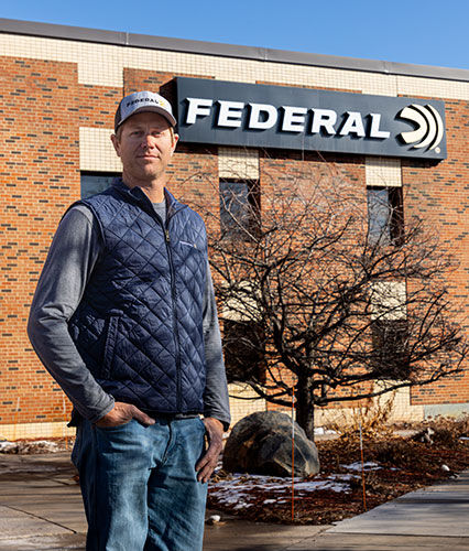 Cory Kruse standing in front of the Federal factory