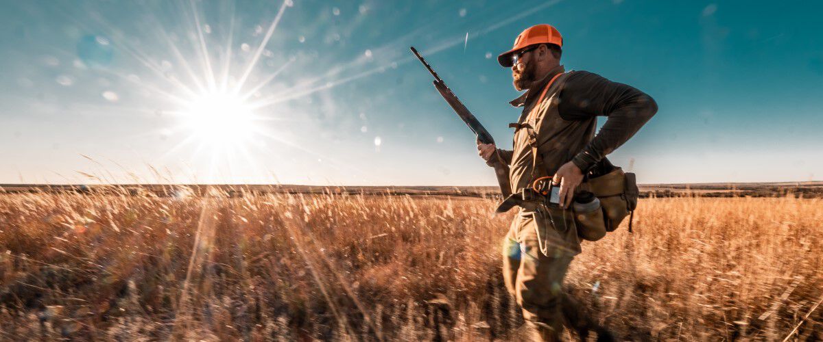 hunter walking in a field