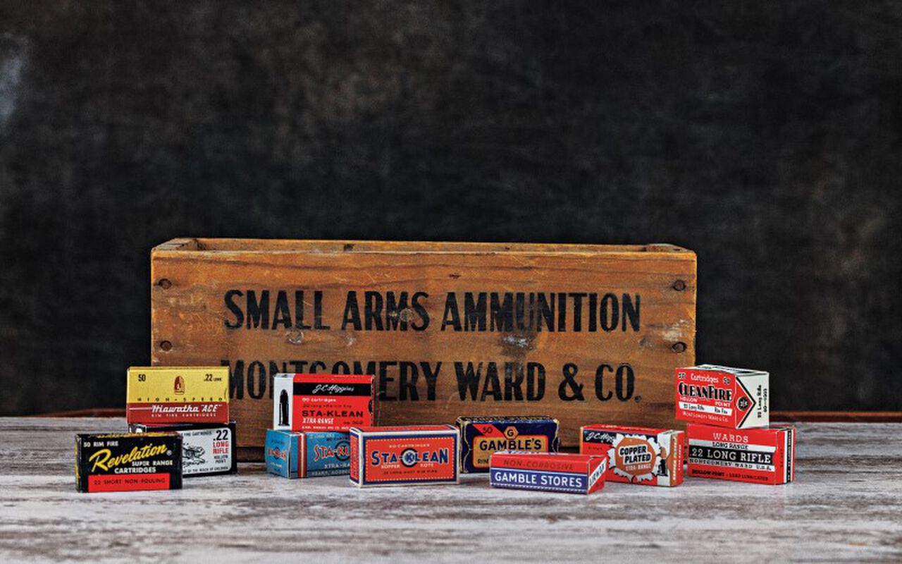 ammo boxes in front of a box with Small Arms Ammunition Montgomery Ward & co written on it