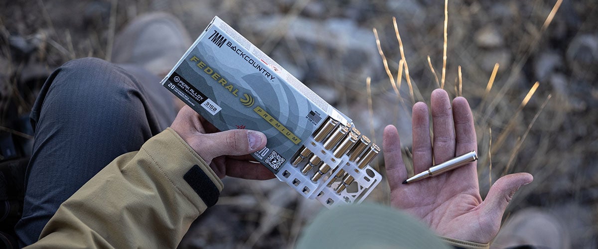 hunter holding 7mm Backcountry box and cartridge