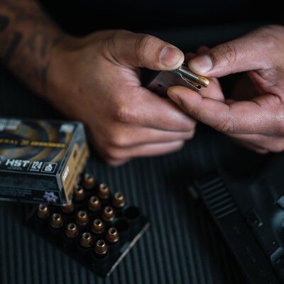 Person loading HST into a pistol