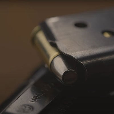 shooter at an indoor range shooting at a target