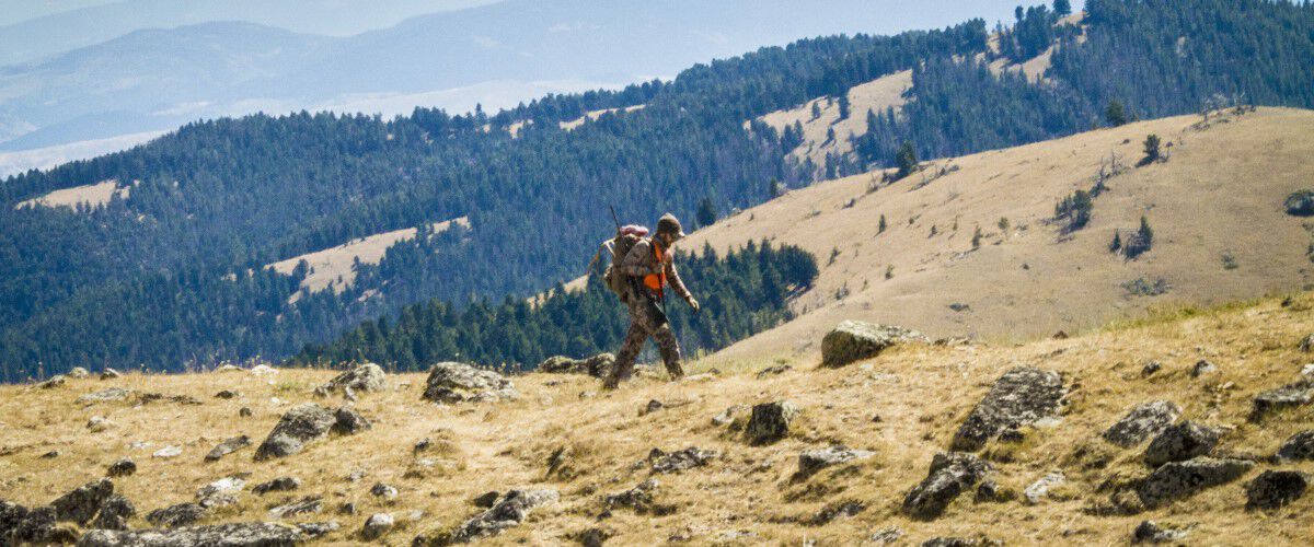 man walking on a rocky hill