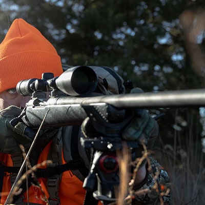 hunter aiming a rifle
