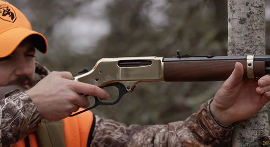 hunter aiming lever action rifle