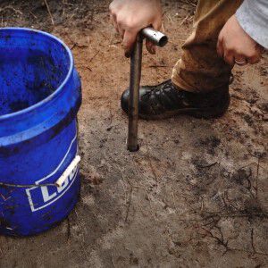 person taking a soil sample