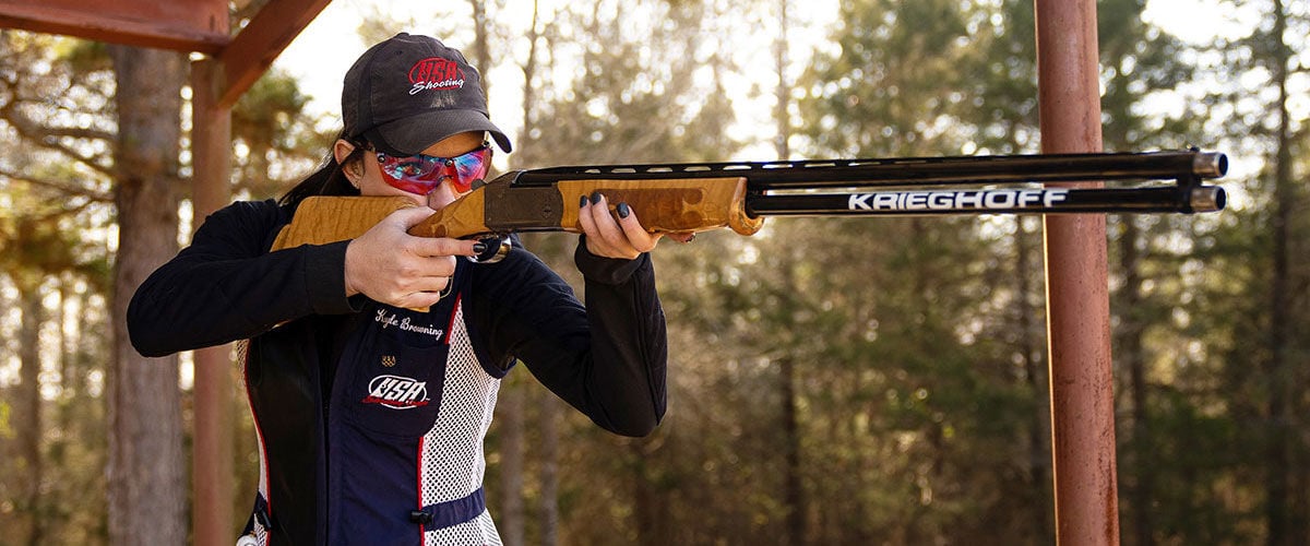 Kayle Browning shooting a shotgun