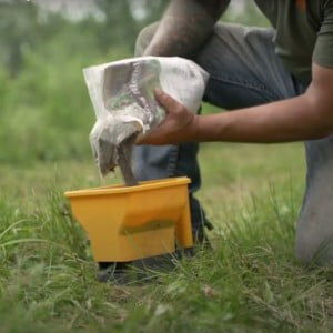 Josh Froelich pouring seed into a bucket