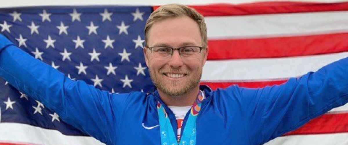 Brian Burrows standing in front of the American flag