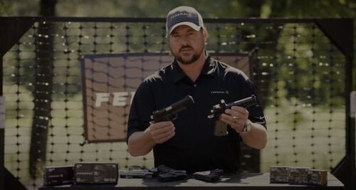 Jim Gilliland holding two pistols