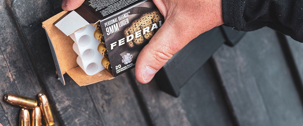 person holding open Punch box with Punch cartridges laying on a table