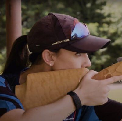 Kayle Browning looking down the iron sights of a shotgun