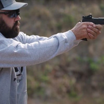 Josh Froelich aiming a pistol