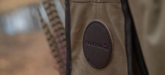 pheasant tail feathers sticking out of the back pocket of the Duluth Pack Vest