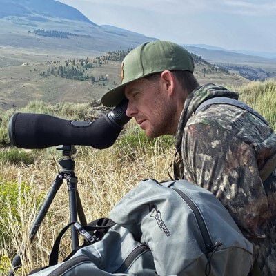 Hunter looking down a spotting scope