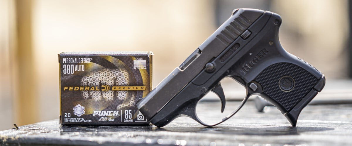 Punch box next to a handgun on a table