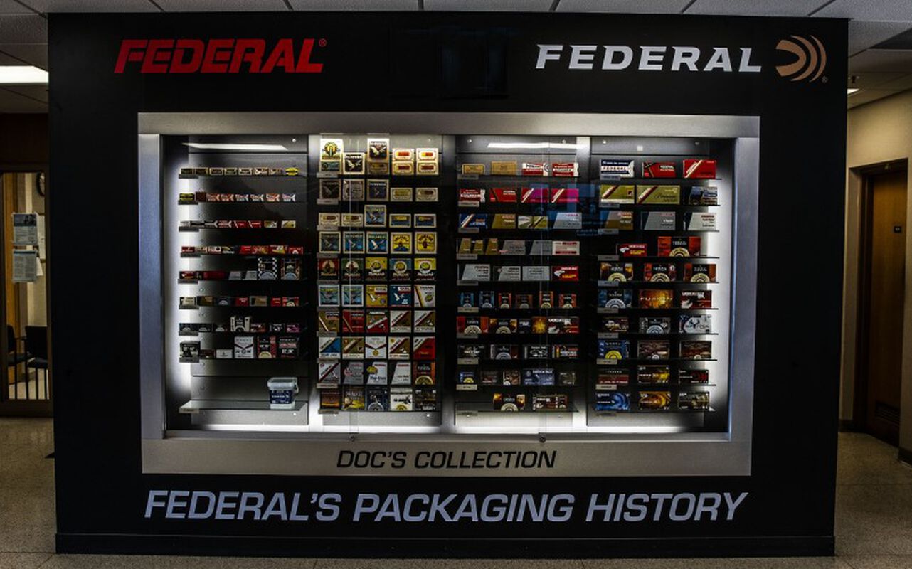 Federal packaging through the years in a large glass case