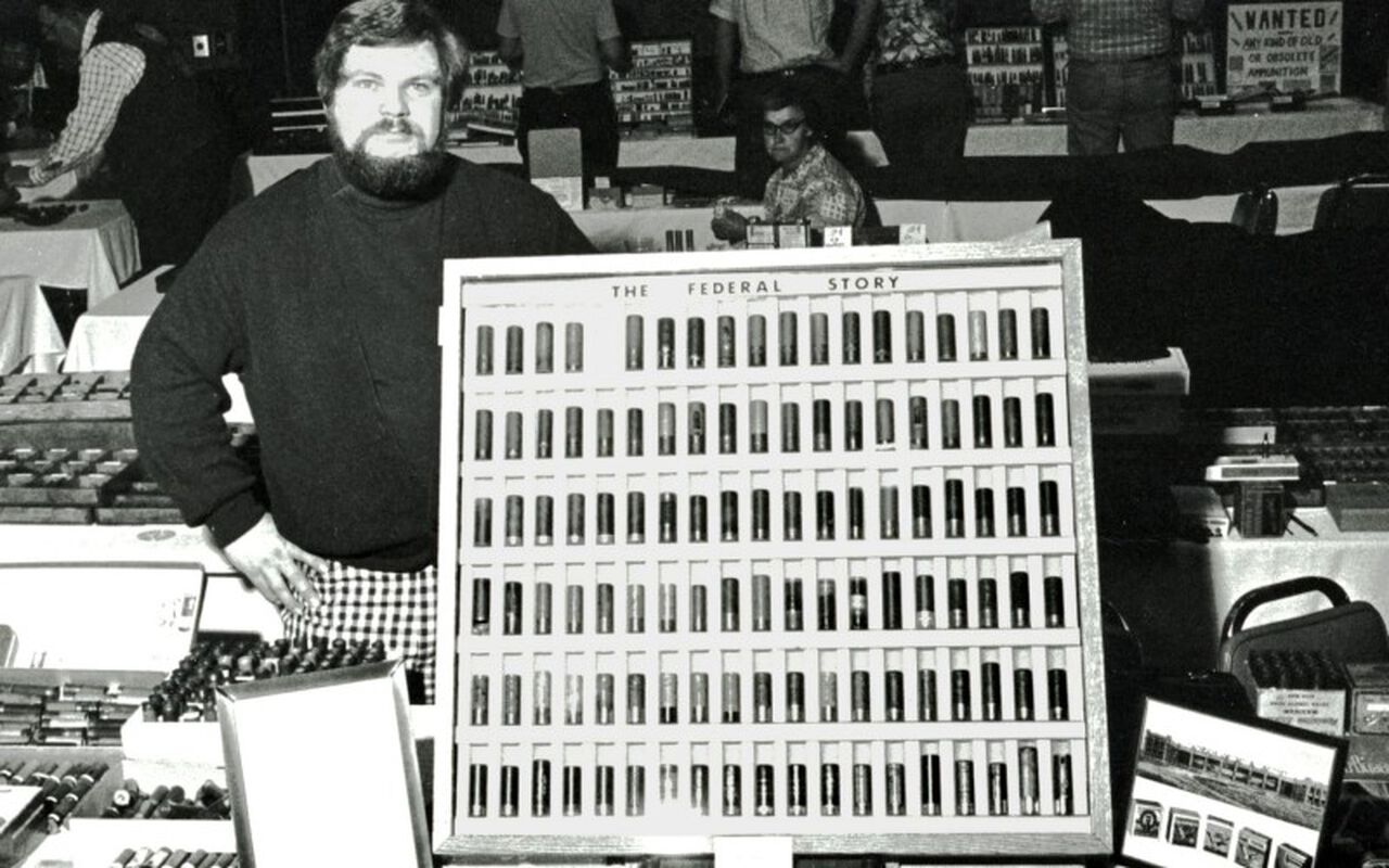 Federal employee standing in front of a board with Federal ammunition on it