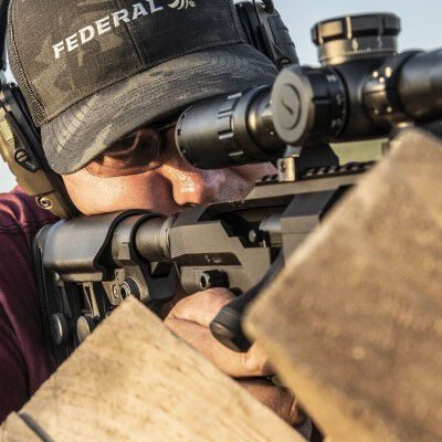 man looking down the scope of a rifle