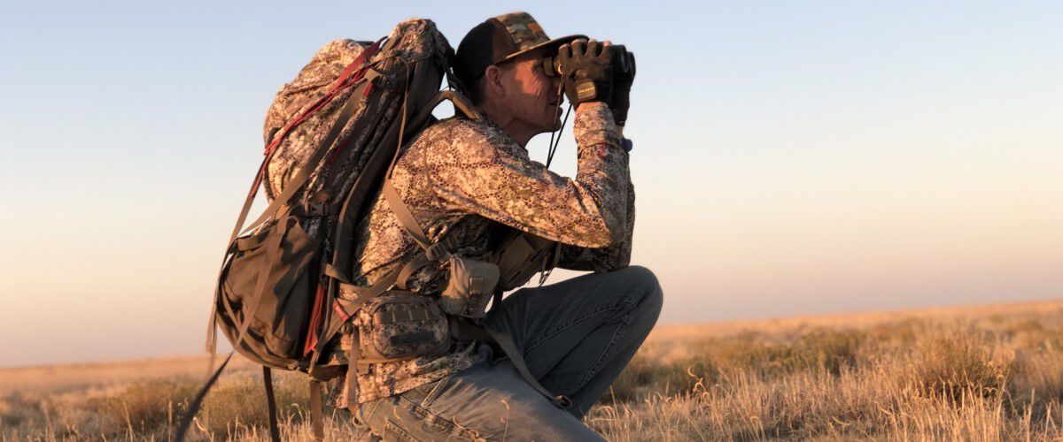 hunter looking through binoculars