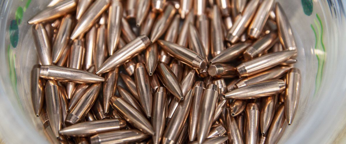 custom rifle bullets in a pail