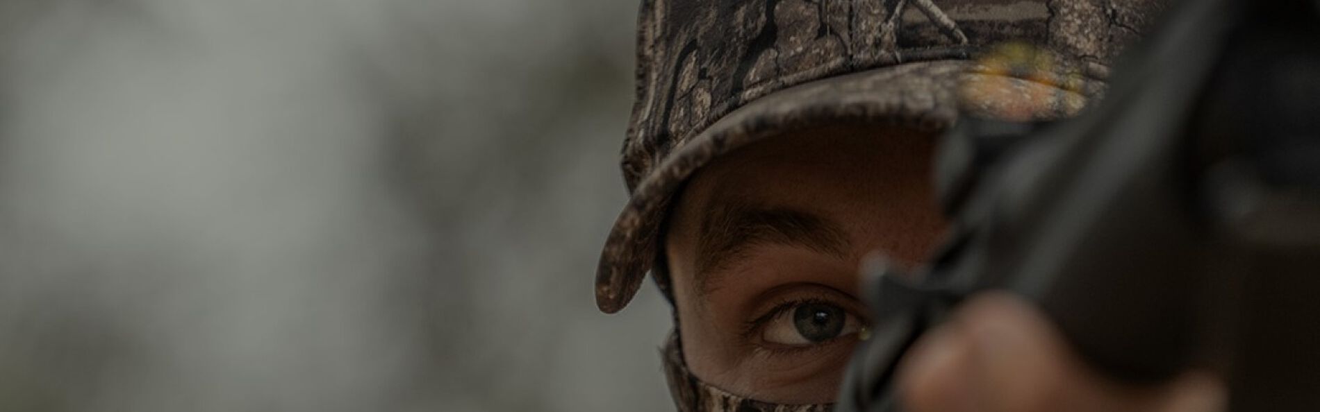 close-up of a hunter looking down the iron sights of a rifle