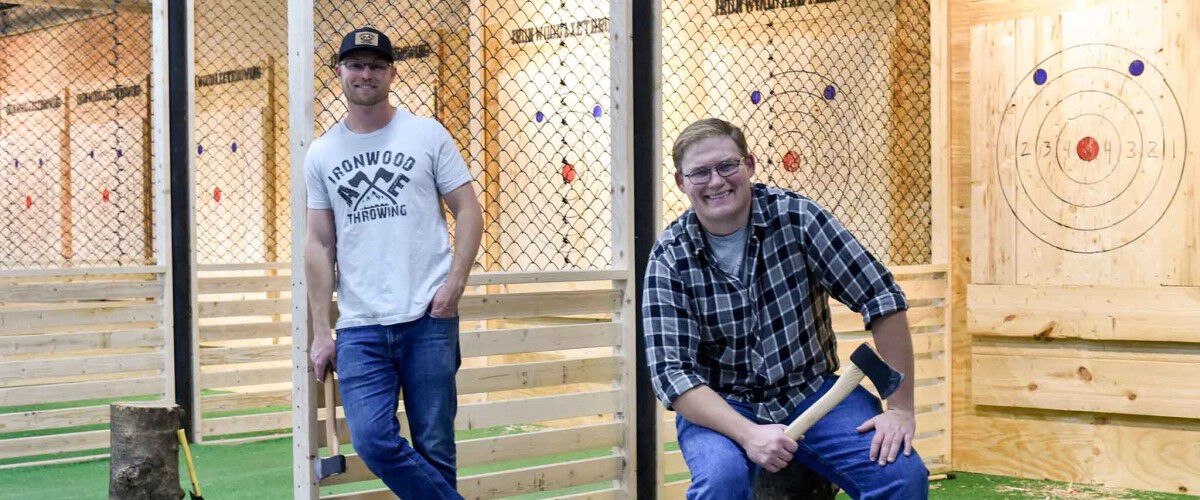 Brian and his brother Jon standing at Ironwood Axe Throwing