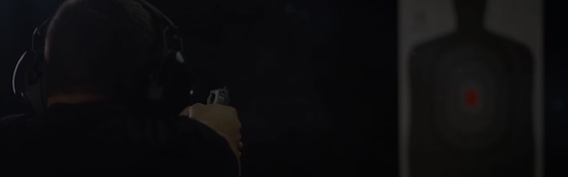 shooter at an indoor range shooting at a target