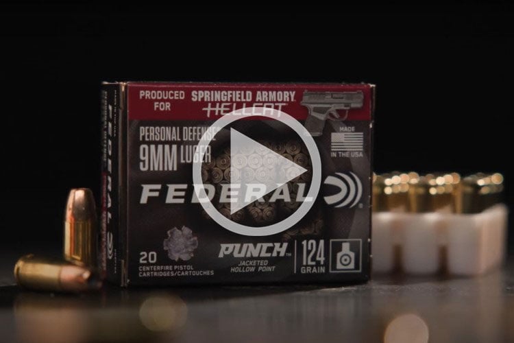 Punch Hellcat packaging and cartridges in front of a Springfield Armory Hellcat