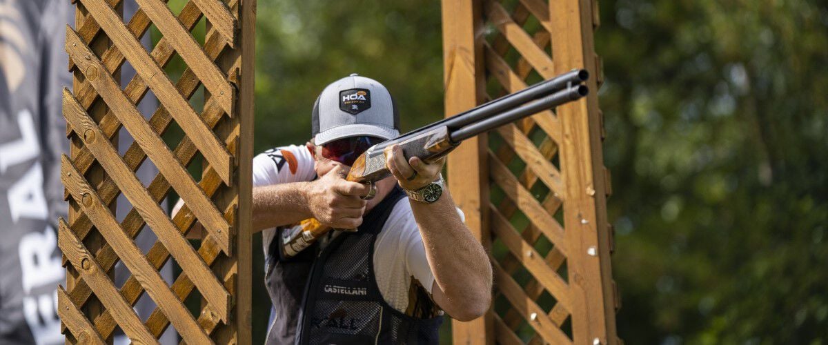 shooter aiming a shotgun